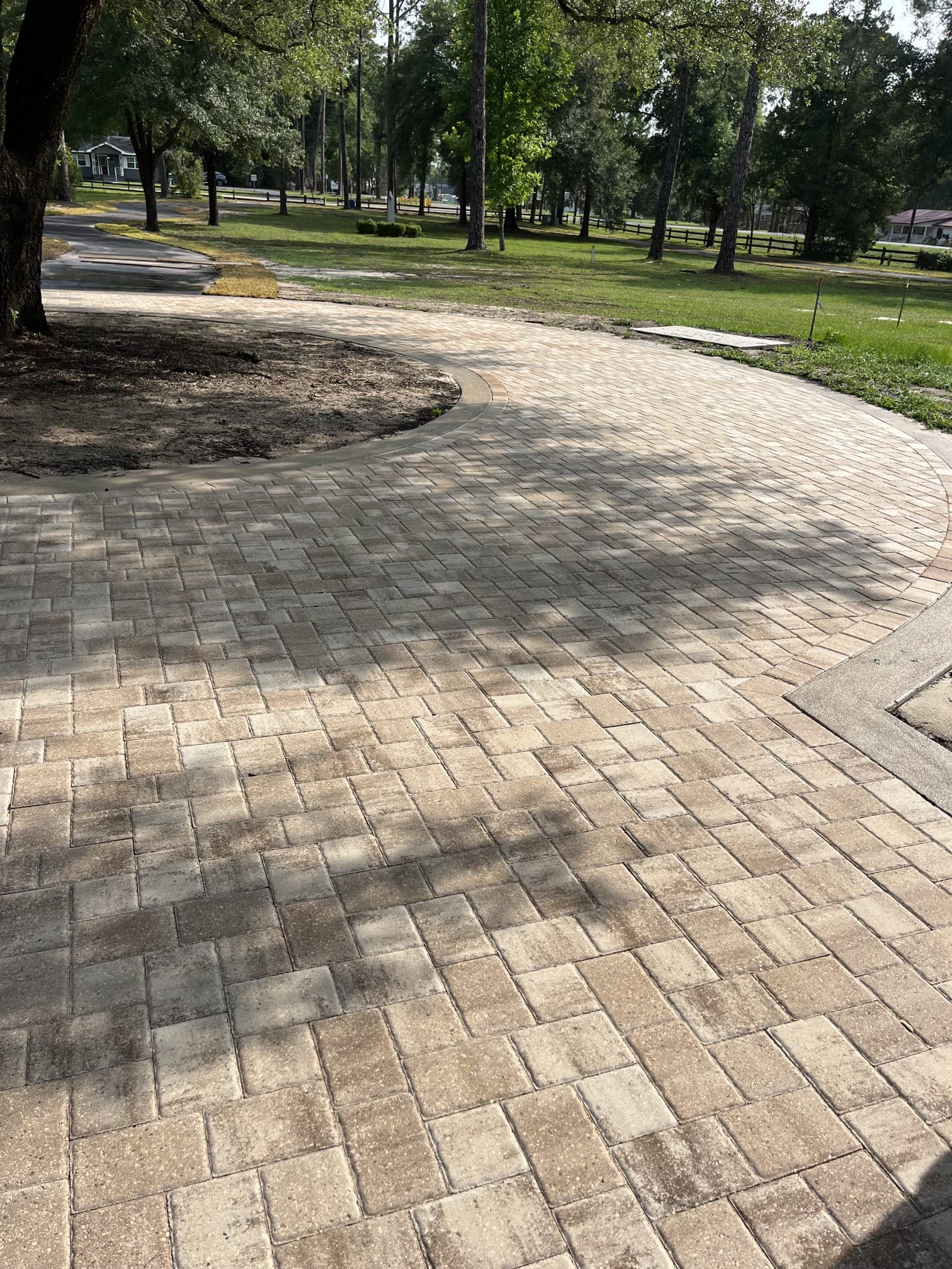 Curved paver driveway installation in North Florida