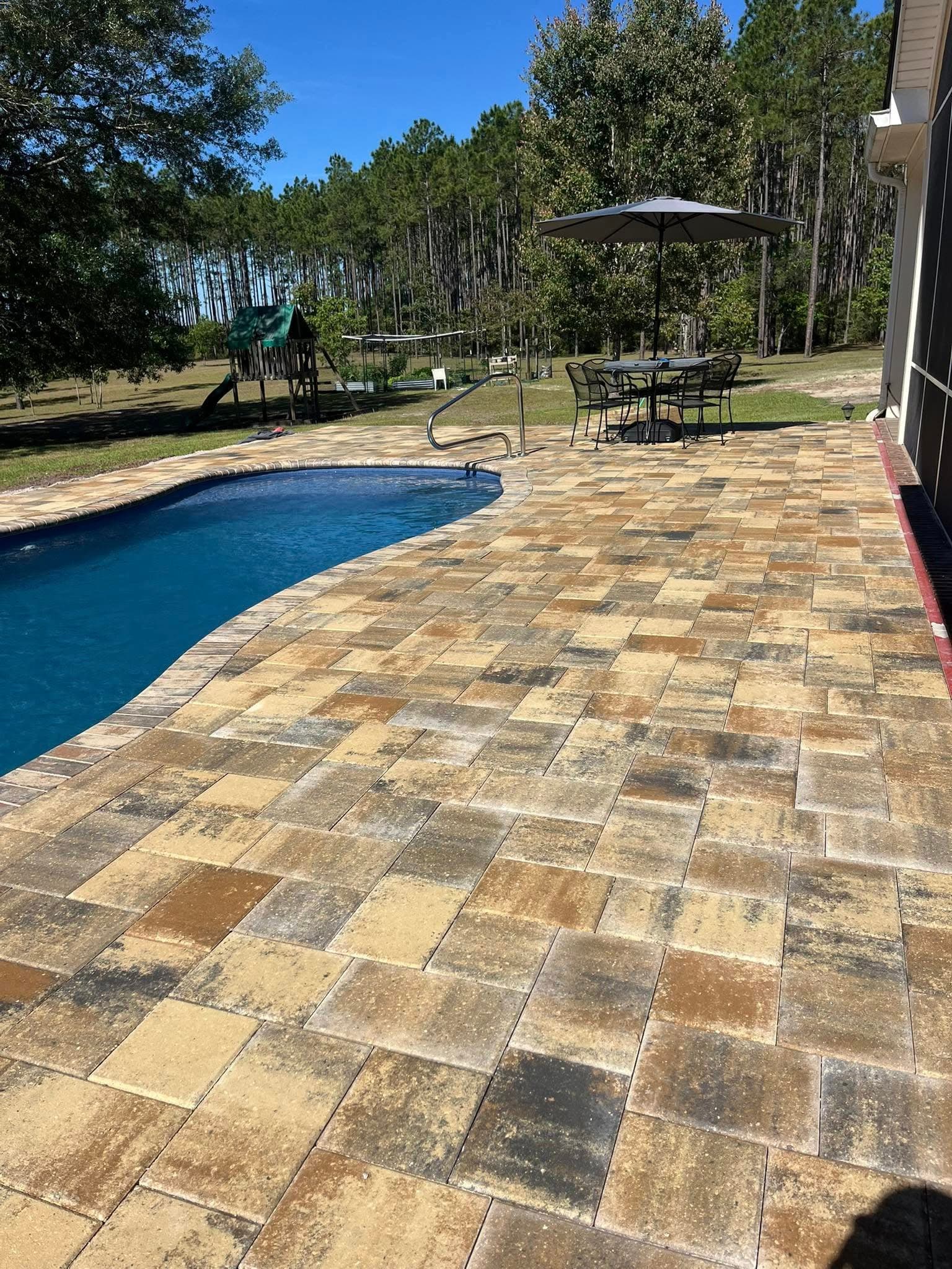 Warm multicolor paver pool deck installation in North Florida